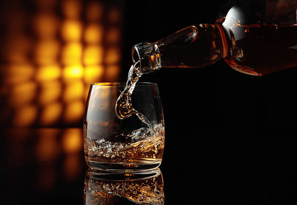 istock Pouring whiskey from a bottle into a glass. 2245809711