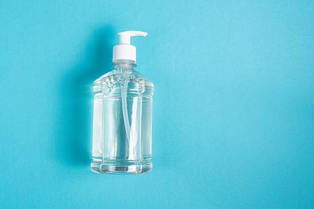 istock Container with alcohol gel on the light blue background 2245811055