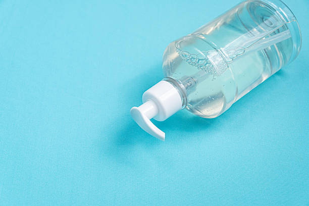 istock Container with alcohol gel on the light blue background 2245811830