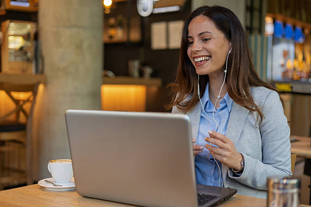 istock Smiling Female Executive on Virtual Meeting in Cozy Cafe Setting 2245812435