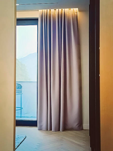 istock A large panoramic window in the room with a hanging curtain. 2245813116