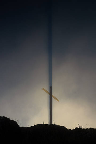 a real cross in sun and fog  perpendicular