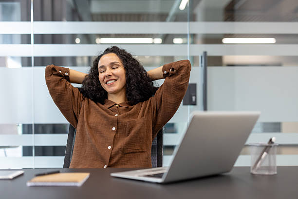 istock Smiling professional relaxing during a break in a modern office environment 2245817530