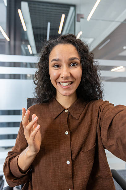 istock Woman Smiling During a Video Call in a Modern Office Setting 2245818068