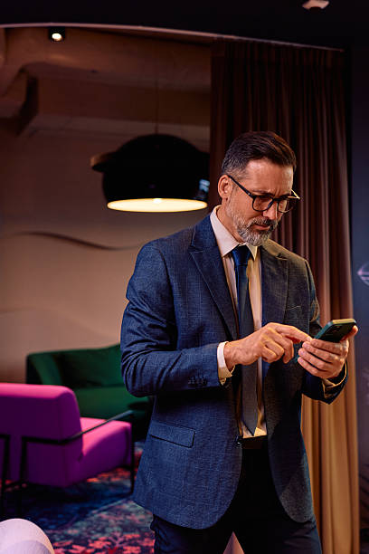 istock Mature adult businessman using smartphone in modern office 2245818516