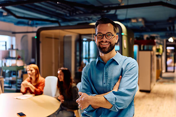 istock Confident businessman standing in modern coworking office 2245818553