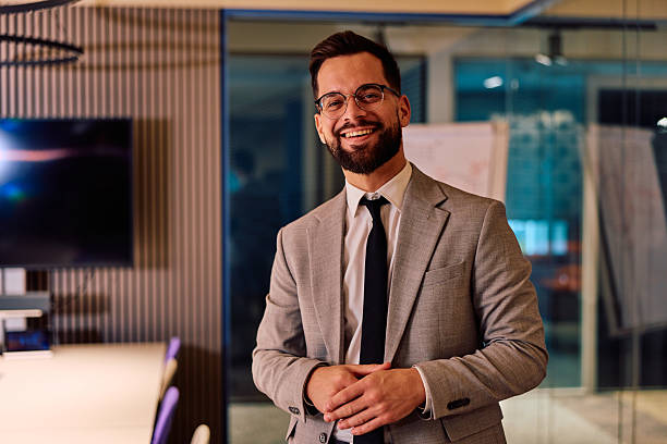 istock Happy young businessman smiling in modern office 2245818624