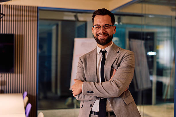 istock Confident young businessman smiling with arms crossed 2245818627