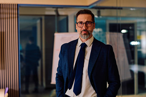 istock Mature businessman standing confidently in office at night 2245818645