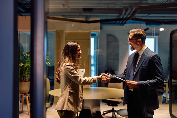 istock Business partners shaking hands making deal in modern office 2245818705
