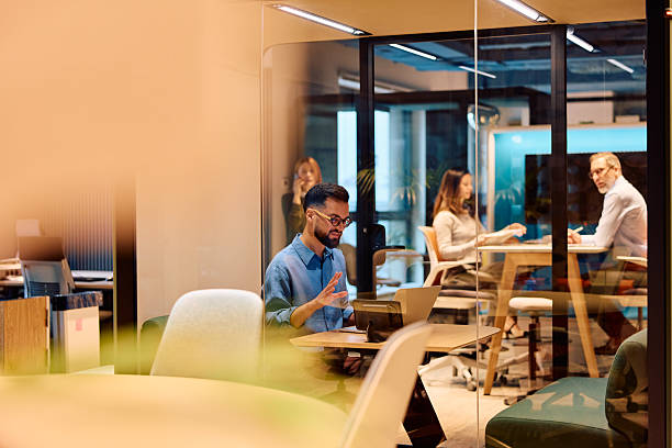 istock Business professional doing remote video call in modern office 2245818908