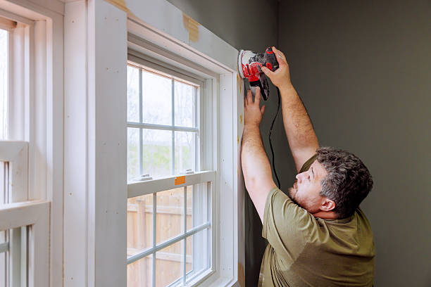 istock Man using power tools to install trim around window in home renovation project 2245820040