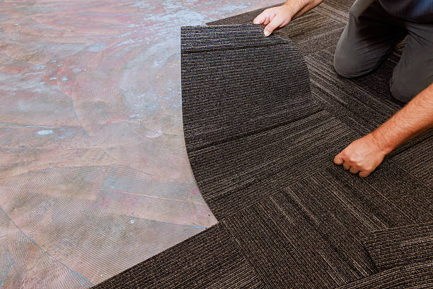istock Installing modern carpet tiles in home interior for fresh updated look 2245820391