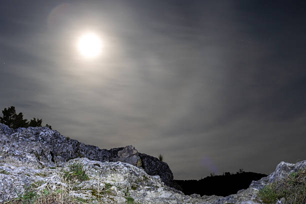 Bright full moon illuminating a rocky landscape in cuenca, spain at night