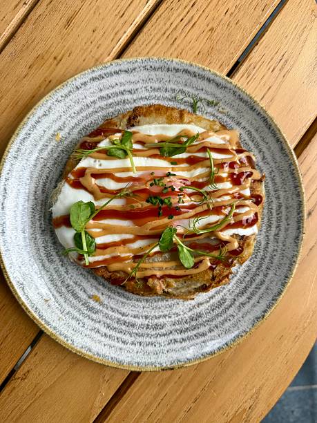 Hiroshima style okonomiyaki with fried  eggs for breakfast