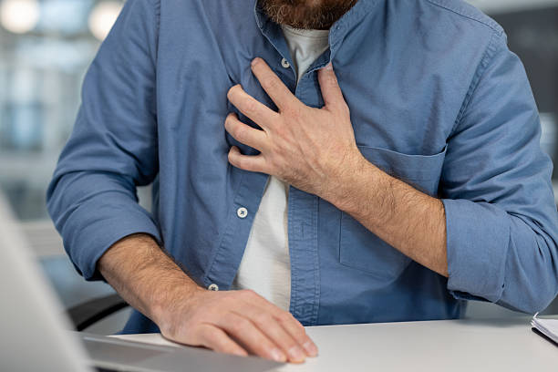 istock Man feeling chest pain at office, health issue 2245824056