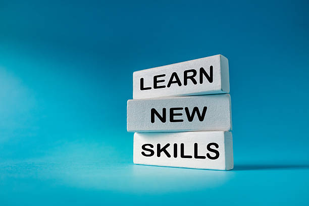 istock Learn new skills. Business concept. Slogan Learn New Skills written on white elements on a beautiful blue background. Development and education. Expanding horizons and building a career. Close up. copy space 2245825792