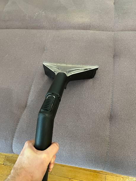 istock washing the sofa with a fabric vacuum cleaner 2245826645