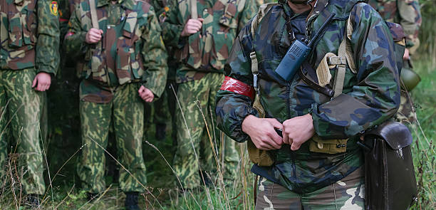 istock Soldiers in camouflage uniforms gather for a training exercise in a forest during early morning hours 2245826739