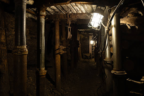 istock Dimly lit mining tunnel with ventilation pipes, cables and belt conveyor in an abandoned coal mine, Czech Republic 2245827071