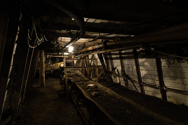 Young miner descending the stairs of a coal mine.