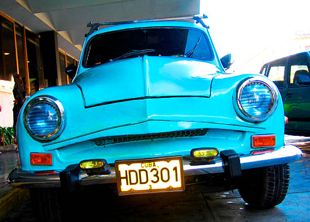 Front view of stationary vintage classic blue car in Havana, Cuba .