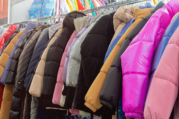 istock Colorful winter jackets hanging on a rack in a store 2245827457