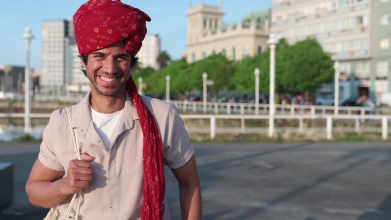 Indian man wearing a turban smiling and looking at the camera