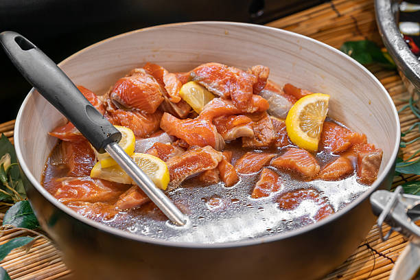 istock Soy marinated fresh salmon slices served in a savory soy sauce mixture with herbs and seasoning. 2245838962