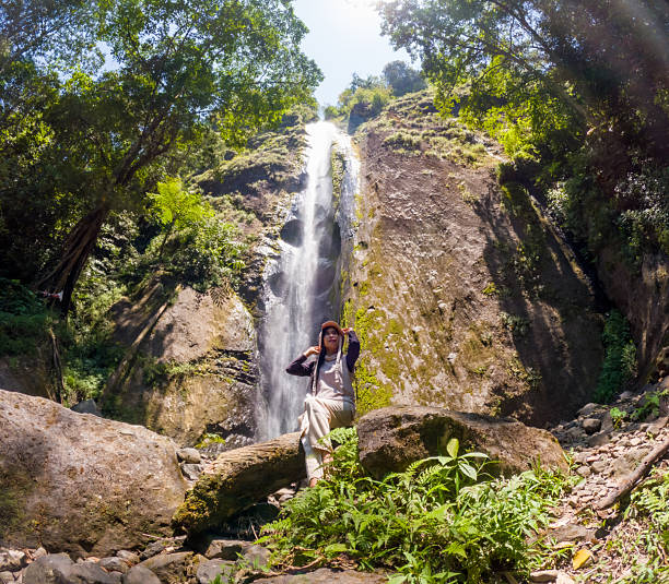 istock Asian woman vacation at Dolo waterfall. One of beautiful waterfall in East Java 2245842681