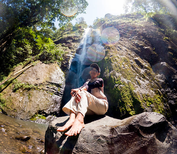 Asian woman vacation at Dolo waterfall. One of beautiful waterfall in East Java