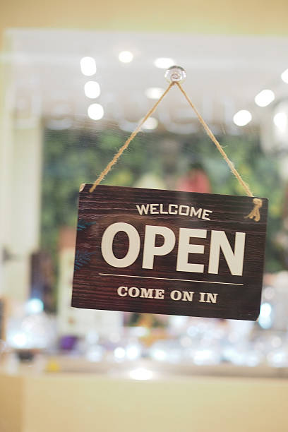 istock Open sign hanging in welcoming shop interior 2245843335