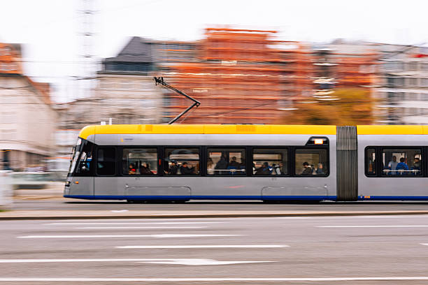 Leipzig, Germany – November 8, 2025: Tram operated by Leipziger Verkehrsbetriebe passes near Leipzig Hauptbahnhof with passengers sitting inside during daily transport operations.