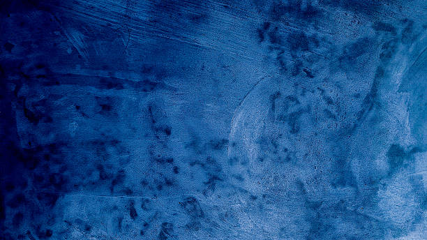 istock Dark blue grungy backdrop with golden splatters. Abstract dark blue concrete texture background. 2245845076