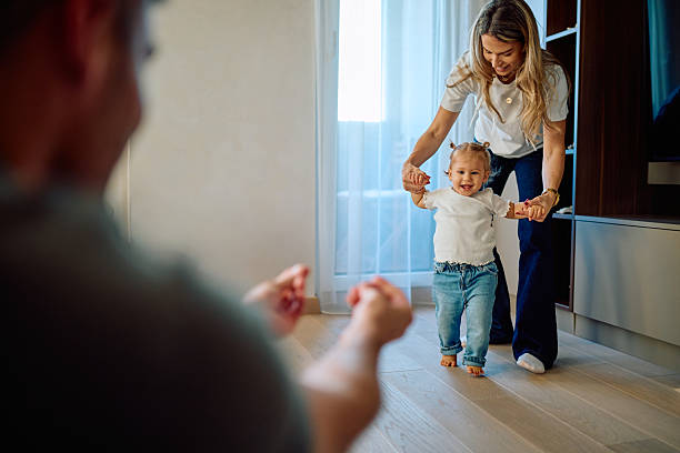 istock Parents helping toddler learning first steps at home 2245845752