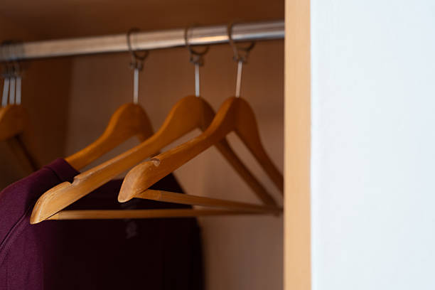 Wooden clothes hanger. Simple and clean home storage solution. Minimalist wooden hanger