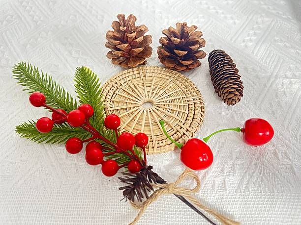 istock Festive Decorations with Pine Cones, Colorful Berries, and Natural Textures on a White Background for Holiday Aesthetic and Seasonal Crafts 2245851151