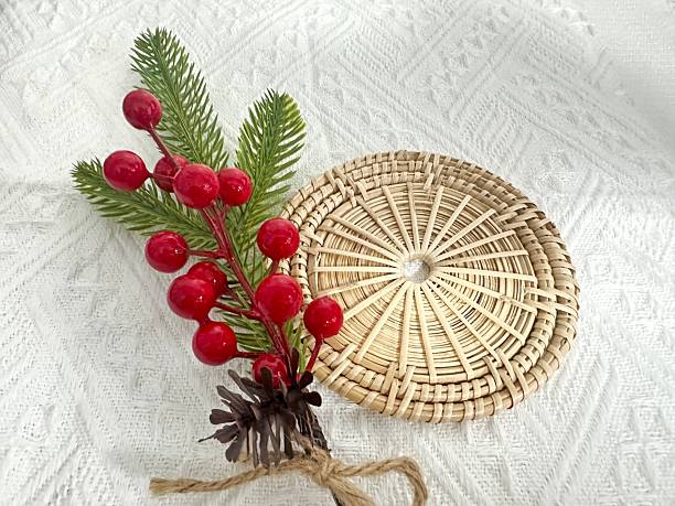 istock Decorative Basket with Pine Sprigs and Red Berries on Textured White Background for Rustic Holiday Decor and Festive Celebrations 2245851433