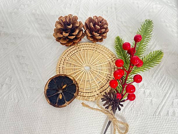 istock Natural Decorative Elements for Festive Occasions, Featuring Pinecones, Dried Citrus, Berries, and Greenery on Woven Base for Seasonal Styling 2245852141