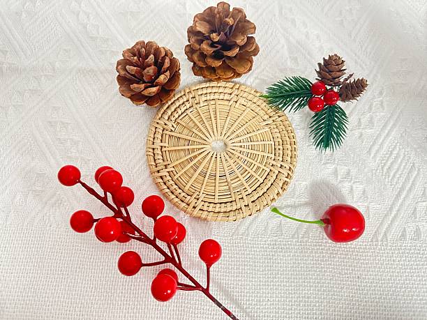 istock Rustic Woodland Decor with Pinecones, Berry Stems, and Woven Basket on White Textured Background for Holiday or Seasonal Themes 2245852213