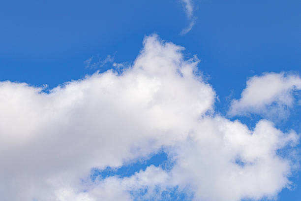 istock Bright blue sky with fluffy white clouds. Natural background with soft cloud shapes illuminated by sunlight. Perfect for weather, nature, and landscape themes. 2245856237