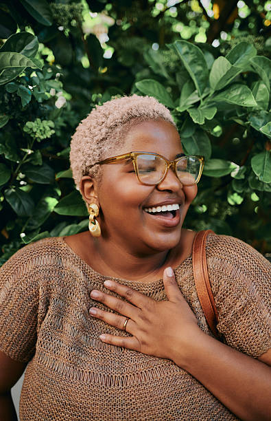 istock Young Creative Black Woman laughing Outdoors Wearing Glasses and Statement Earrings 2245858728
