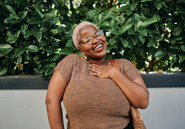 istock Young Creative Black Woman Smiling Outdoors Wearing Glasses and Statement Earrings 2245858748