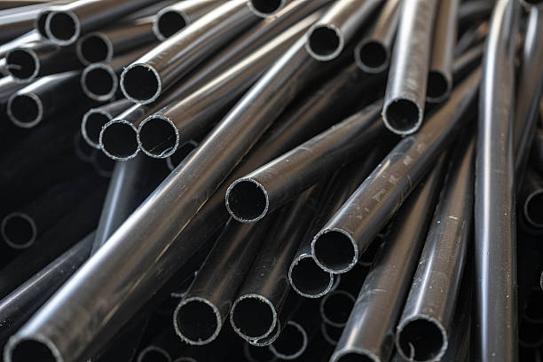 istock Close-up of black plastic pipes stacked in industrial setting with texture 2245859291