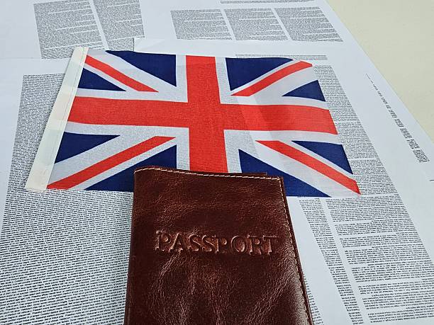 istock British flag and passport placed on printed documents in a travel preparation 2245859803