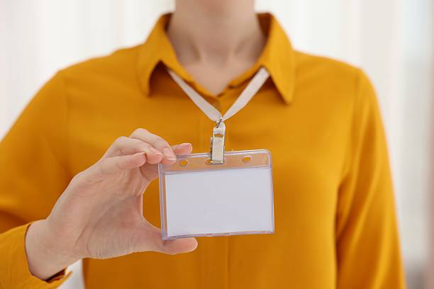 istock Woman with blank badge indoors, closeup view 2245860681