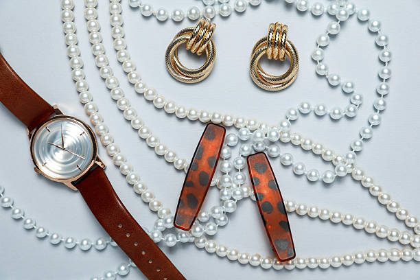Flat lay composition with jewelry and watch on light grey background