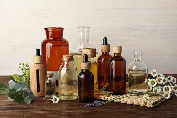istock Aromatherapy. Different essential oils and flowers on wooden table 2245862577