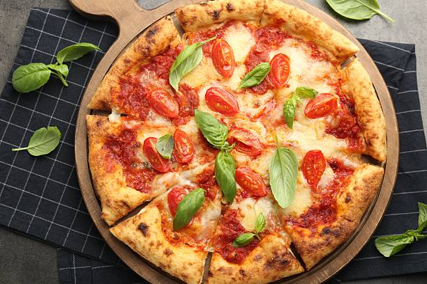 istock Delicious Margherita pizza and basil on grey table, top view 2245863112