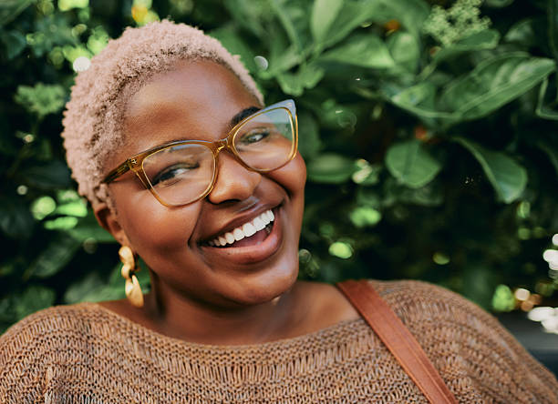 istock Young Creative Black Woman Smiling Outdoors Wearing Glasses and Statement Earrings 2245865075